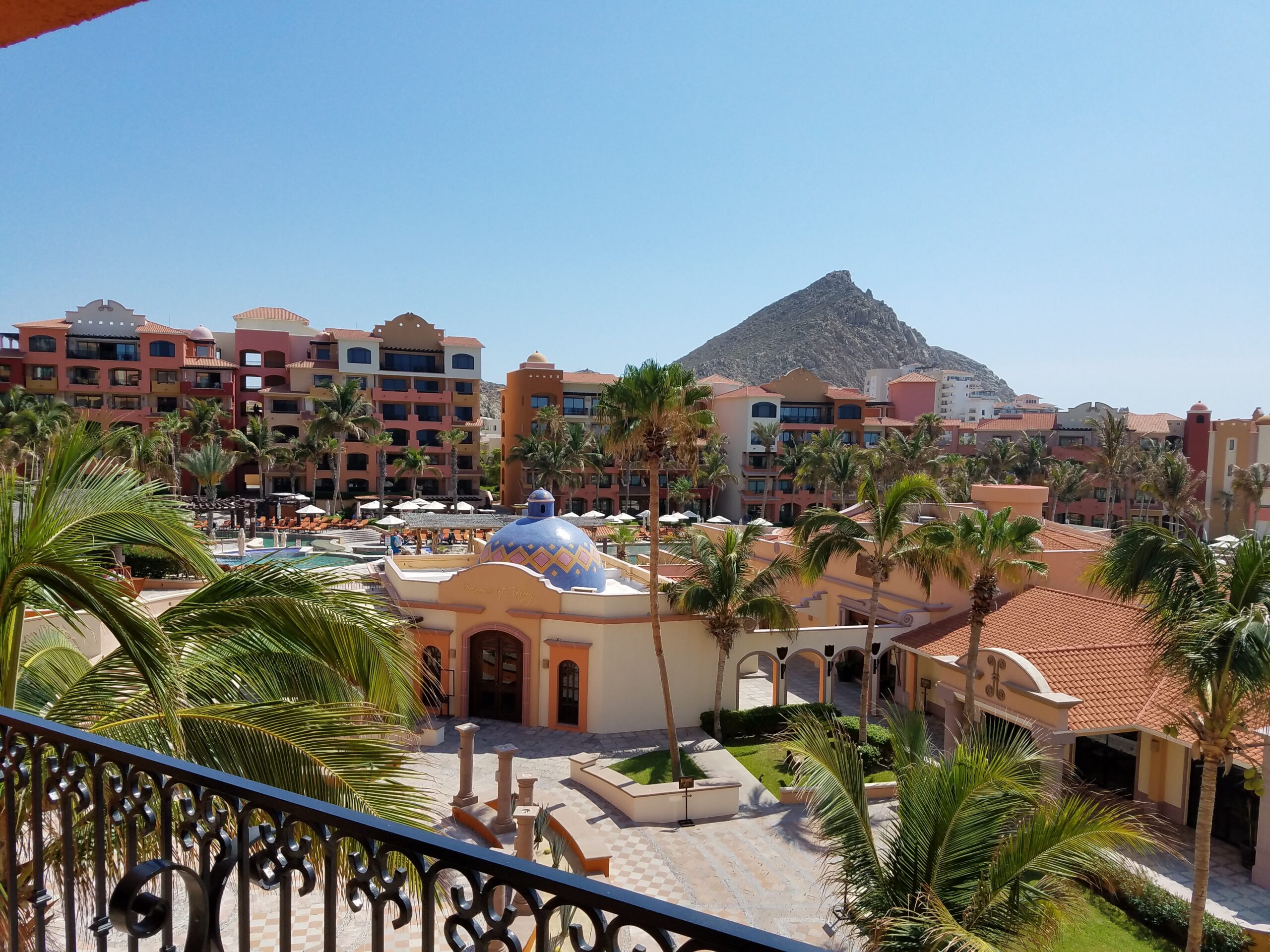 "Traveler overlooking a sun-kissed tropical coastline, representing The Destination Specialists’ commitment to unforgettable luxury experiences."