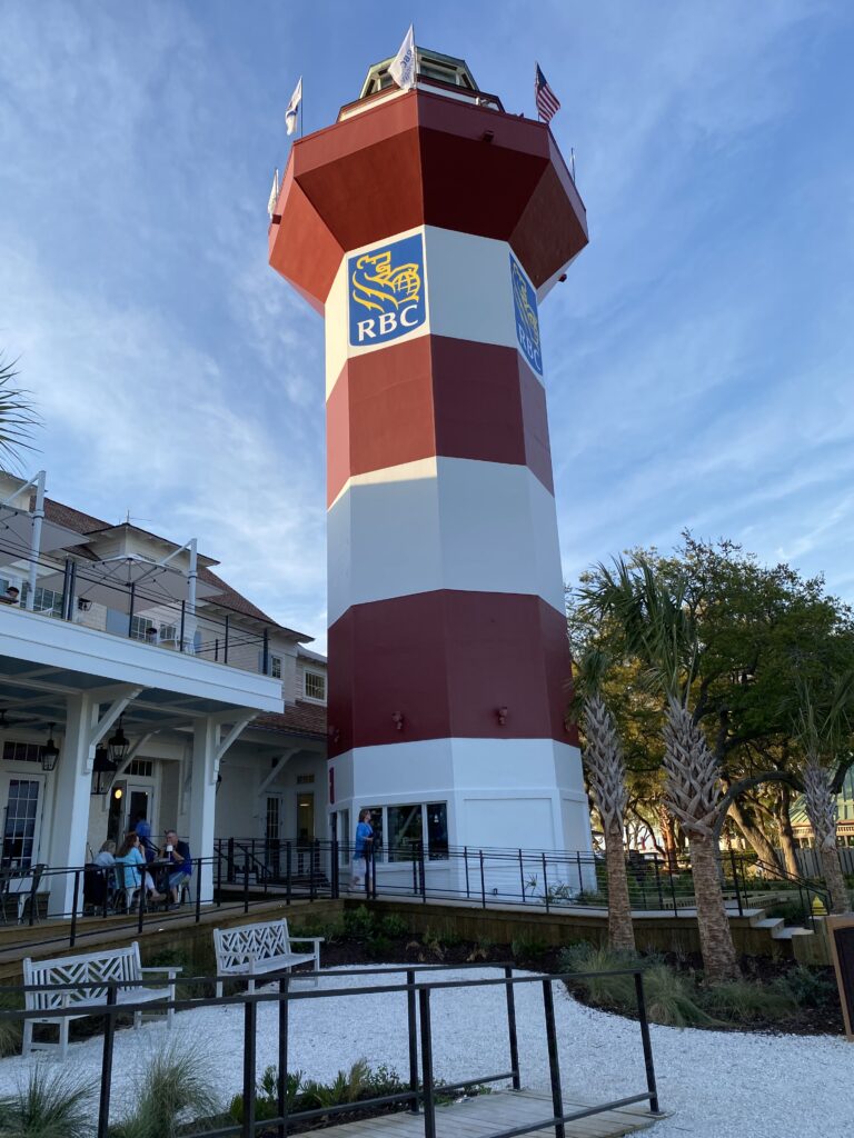 "The Harbour Town lighthouse at Hilton Head Island overlooking the Travelers Championship golf course, curated as a luxury golf travel experience by The Destination Specialists."