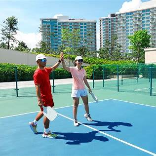 Couple holding pickleball paddles